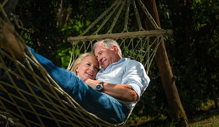 Couple relaxing in hammock after finalizing estate management & planning details with BOK advisor.